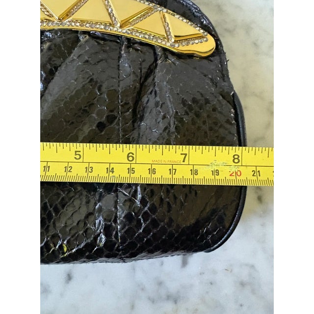 80s chic, snake skin and gold tone handbag with wrapped gold chain over leather shoulder strap.