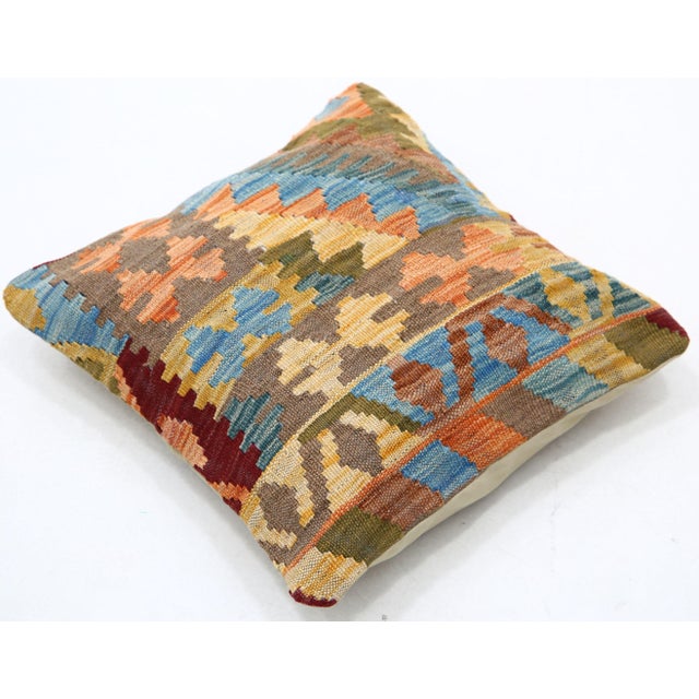 A one-of-a-kind handwoven Afghan wool kilim accent pillow featuring geometric patchwork. Cut and sewn by hand from a flat-...