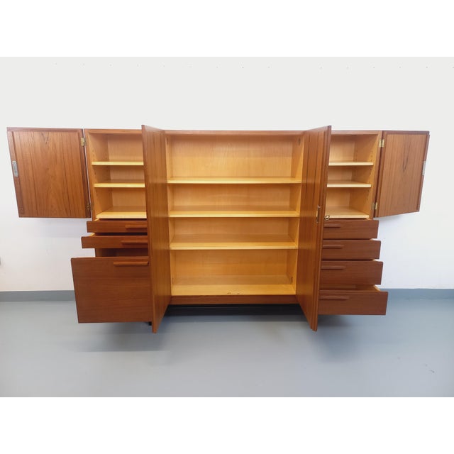 Tall Scandinavian sideboard from the 1960s, modernist style, in teak with black metal legs and beautifully crafted...