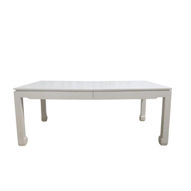 A rectangular dining table fully wrapped in white textured linen, drawing inspiration from the refined, sculptural...