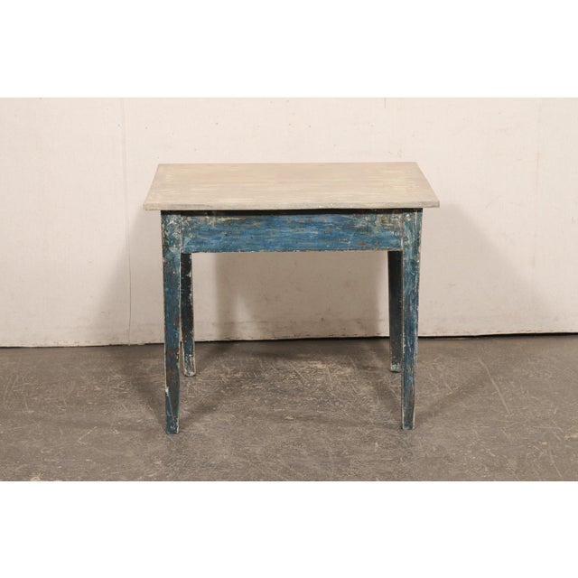 A Swedish painted wood accent table from the 19th century. This antique table from Sweden has a simple, unassuming design...