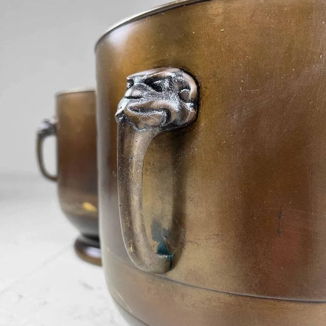 Beautiful set of brass hibachi decorated with an engraved motif of birds and corn stalks. The handles feature an animal...