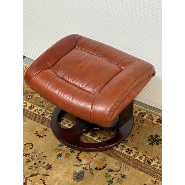 Design Plus Gallery presents a Faux Leather Footstool with Mid Century Vibes. The footstool is similar to Ekornes...