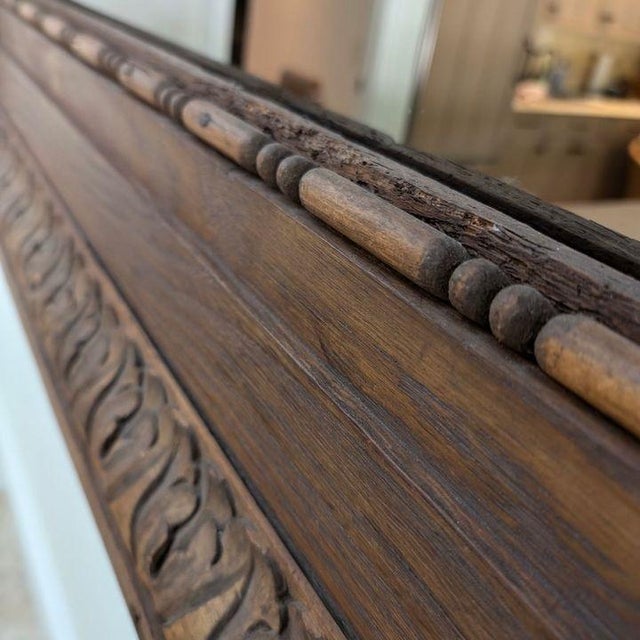 Large Carved Wooden Mirror This is a large presence without being fussy. Heavily carved wood in an oversized wood frame....