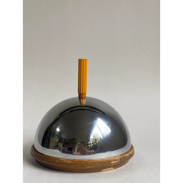 Beautiful and hard to find cheese dome set. Made of stainless steel with a wooden base and adorned with a Bakelite handle....