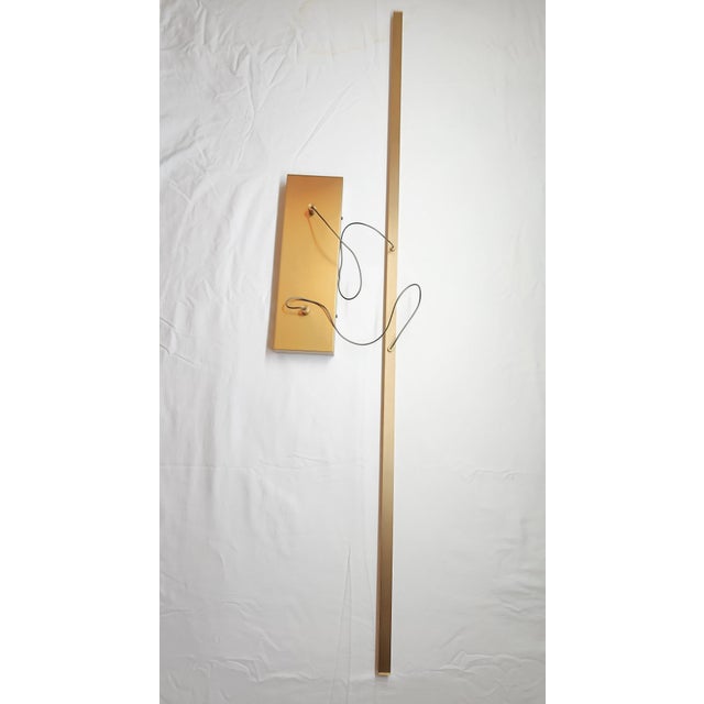 A refined and architectural Essence Linear Suspension Light by Sean Lavin for Visual Comfort, featuring a sleek solid...