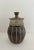 Mid-century handcrafted pottery jar. Shades of brown & taupe, with speckled and striped design.
