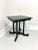 An Asian style square accent table, unbranded. Solid hardwood with a black crackle finish, miter edge to the top, carved...