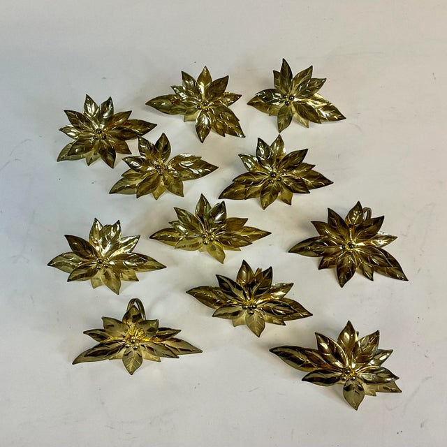 These are a set of 11 large Christmas brass napkin rings. They are poinsettia botanicals with layers of leaves and pedals....