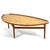 A sublime shape, a wonderful large scale, and delightful details all mark this coffee table by Danish master Finn Juhl....