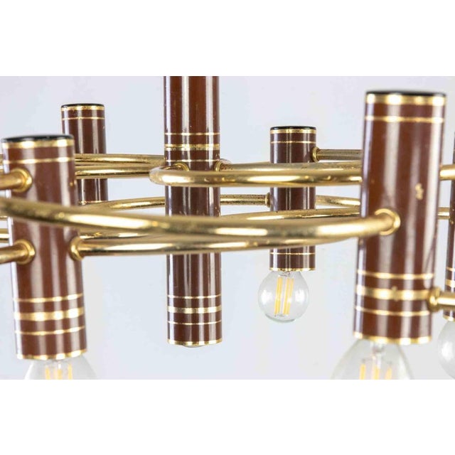 Mid-century Chandelier in golden metal realized by Gaetano Sciolari in 1960s. Minor signs of age due to the time,...
