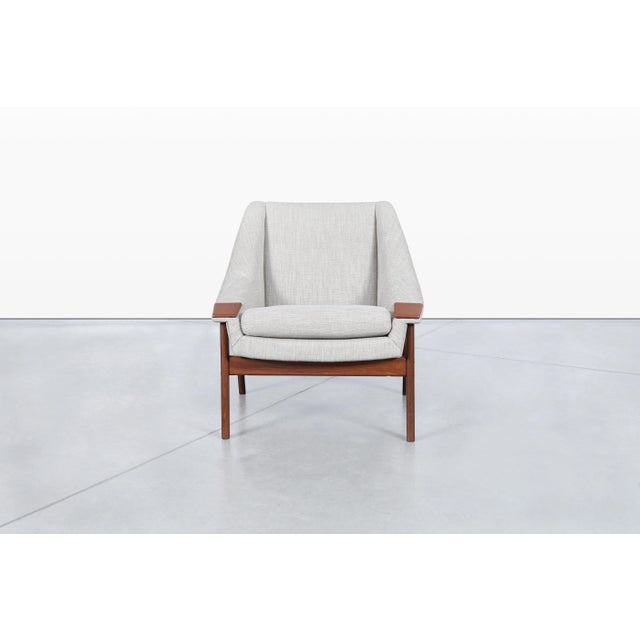 Mid-century modern walnut armchair attributed to Folke Ohlsson for DUX, manufactured in Sweden during the 1950s. A...