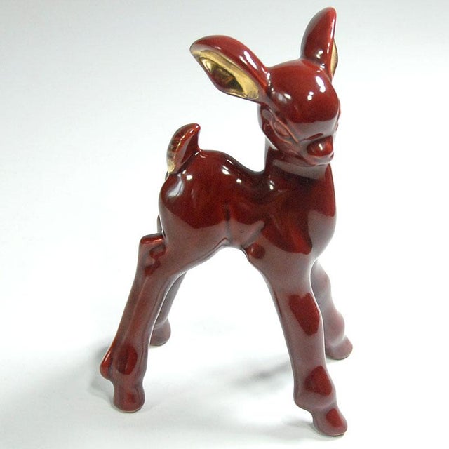 A ceramic, glazed and delicately gilded Bambi deer figurine designed in the Art Deco style. This original vintage item...