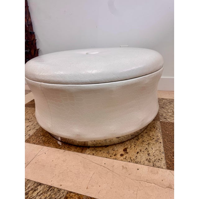 Round white faux alligator ottoman with a low, oversized form and chrome plinth base. Great glam/postmodern piece for use...