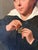An exceptionally charming and unusual French School portrait dating to the late 18th or early 19th century, depicting a...