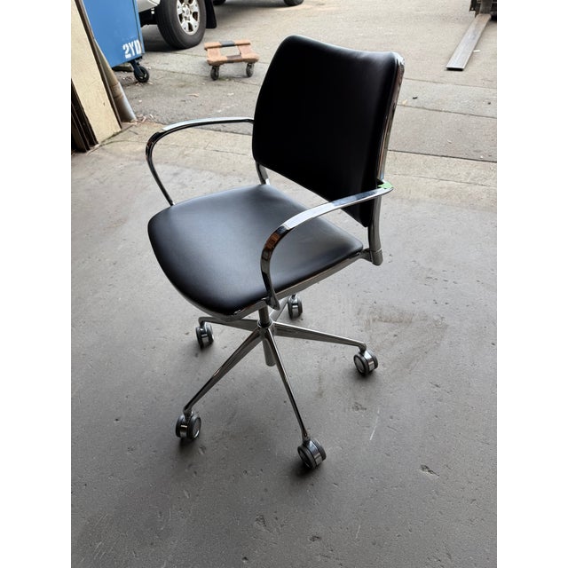 This modern office chair designed by Jesús Gasca features a fluid minimalist chrome-plated aluminum frame and a premium...