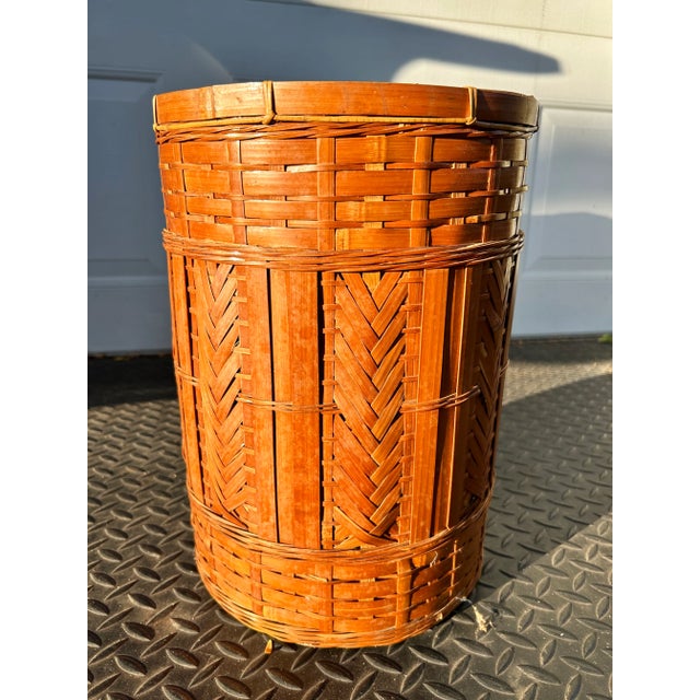 Tall cylindrical woven basket in a natural camel brown. Great storage or perfect to hold a plant or dried flowers. A nice...