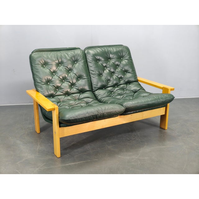 Mid-century two-seat sofa produced in Czechoslovakia during the 1970s, featuring a solid beech wood frame and original...