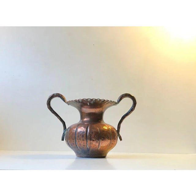 A sculptural handled vase in hand embossed copper. It displays all the right elements of Scandinavian Brutalism. Anonymous...