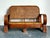 This charming vintage woven rattan loveseat is a refined example of mid-century craftsmanship, celebrating the era’s...
