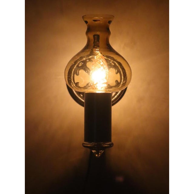 This is an outstanding wall lamp made during the 1960s. it has a beautiful glass shade in an onion shape. it is a Swidish...