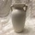 This vintage red wing magnolia pottery vase is known for its elegant design and stunning glaze. It features a soft creamy...