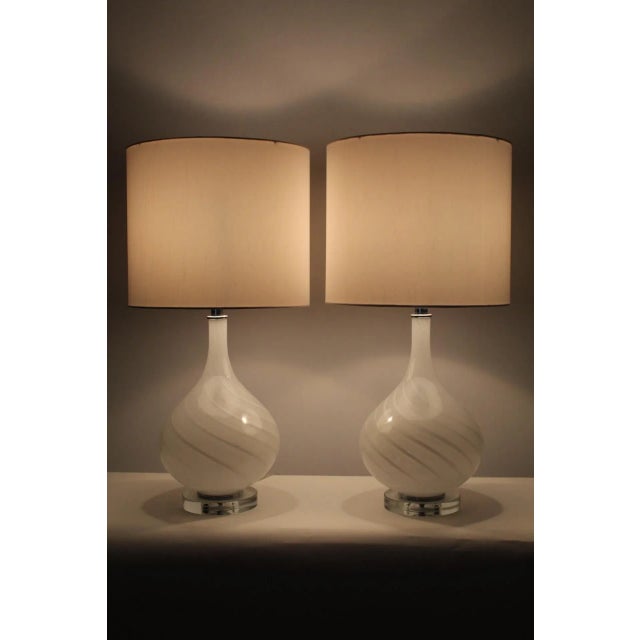 A pair of Puleguso influence Murano table lamps. Beautiful linen white. Swirled pattern making pieces even more in depth...