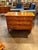 The product is an antique German Biedermeier inlaid walnut commode. This piece of furniture is a dresser or chest of...