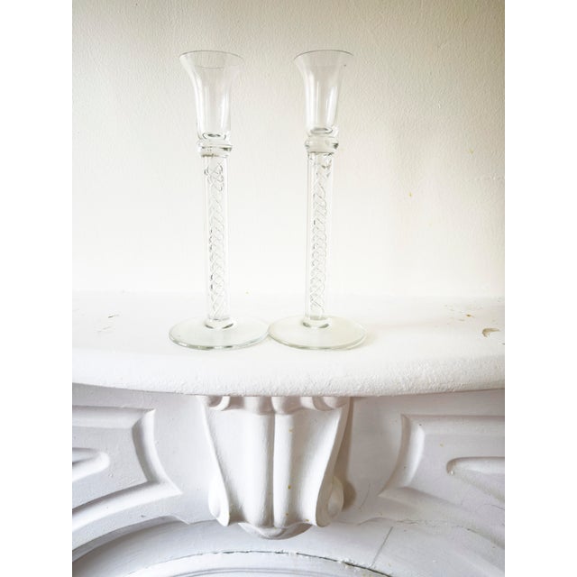 This pair of vintage 1960s candlesticks features clear glass stems with a spiral of trapped air bubbles running through...