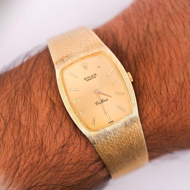 Vintage Rolex Cellini manual-wind dress watch in 18K yellow gold featuring a tonneau-shaped case with a champagne dial,...