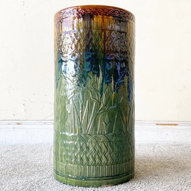 Amazing vintage boho chic glazed clay floor vase. Features a etched exterior with a green orange and blue finish.