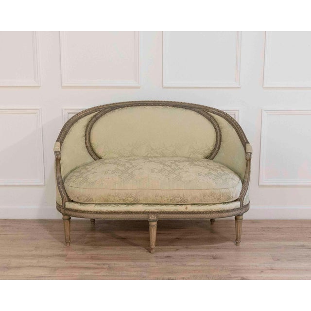 This elegant canapé corbeille exemplifies the refined comfort and graceful proportions of Louis XVI–style seating. The...
