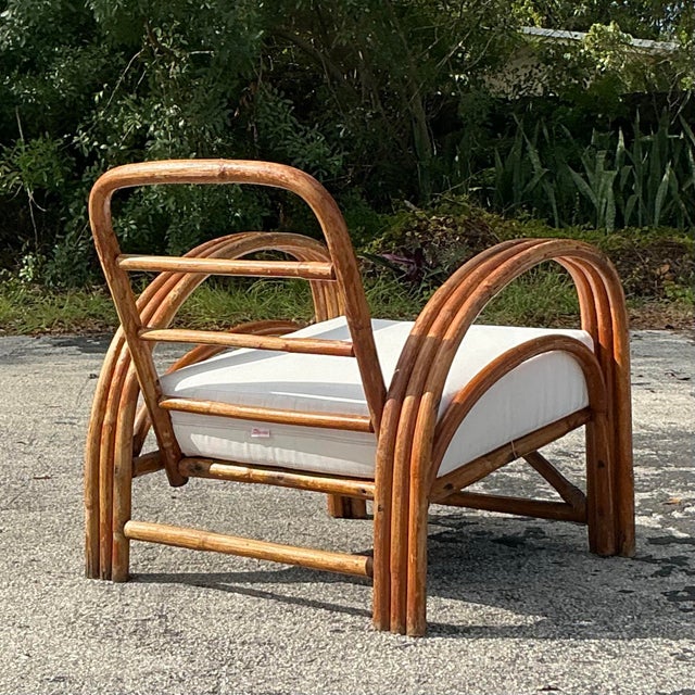 Add a touch of boho chic to your home with this vintage bent rattan lounge chair. Its gracefully curved frame and woven...