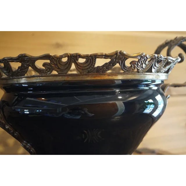 A beautiful black glass bowl which is mounted in bronze with two handles and ornate scrolling. This piece is in very good...
