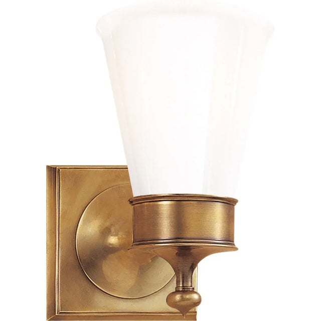 Siena Single Sconce in Hand-Rubbed Antique Brass with White Glass Height: 8.25" Extension: 6.5" Backplate: 4.75" Square...