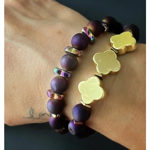 The Fleur De Lis Purple Agate Beaded Bracelet is not only a stunning handmade accessory but also carries symbolic meaning....