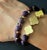 The Fleur De Lis Purple Agate Beaded Bracelet is not only a stunning handmade accessory but also carries symbolic meaning....