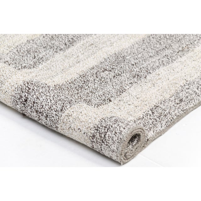 This is a vintage Turkish Oushak rug from the Mid 20th Century. The piece was hand-knotted.