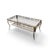 An estimated late-20th-century rectangular coffee table pairing a clear glass top with an ornate gold-toned metal frame....