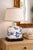 A refined vintage table lamp featuring a hand-painted blue and white porcelain body, beautifully detailed with floral and...