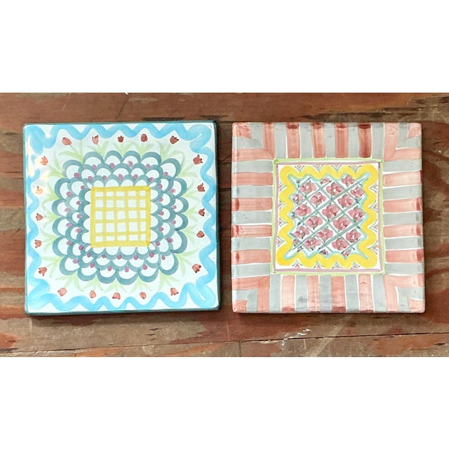 Infuse your tabletop with the whimsical charm and artisanal heritage of this set of two vintage ceramic trivets by...