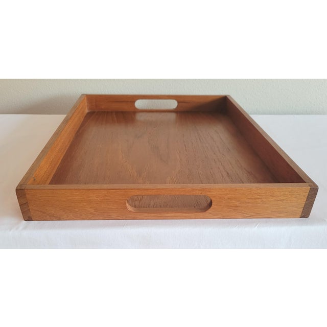 Timeless elegant Danish Modern solid teak serving tray. The trays simple design is a seamless blend of vintage charm and...