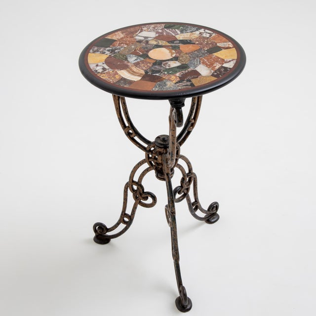 Delicate gueridon featuring a round tabletop in exquisite Pietra Dura inlay, composed of various colored marbles. The top...