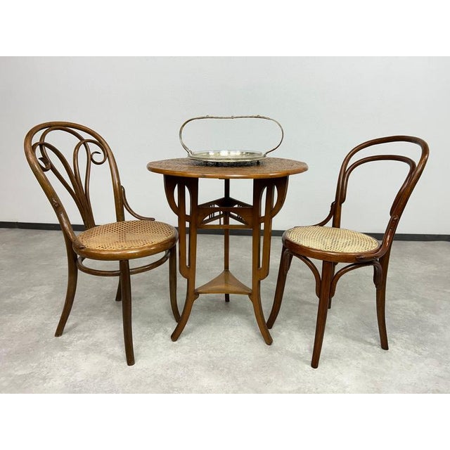 Round art nouveau table with carved top in nice original vintage condition.