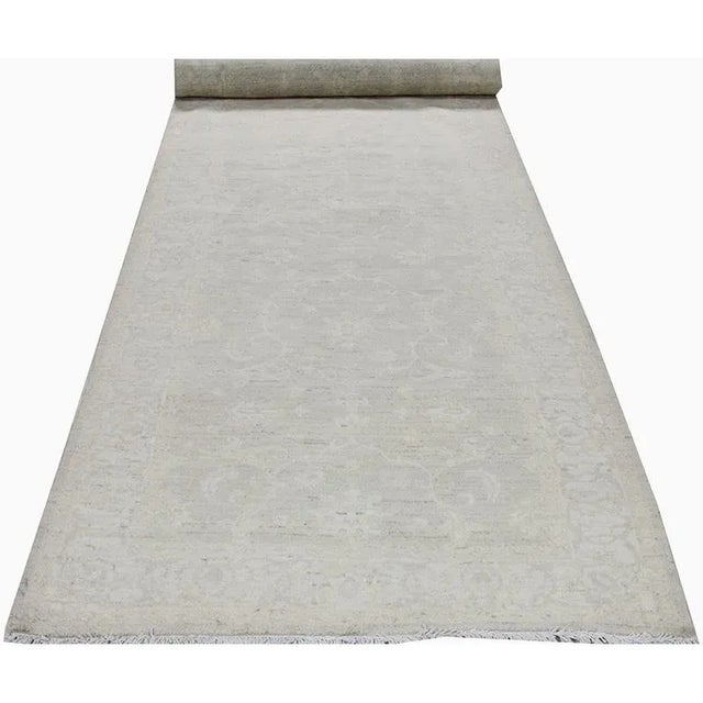 Transitional Handwoven Oushak Style Area Rug featuring an allover design in a beige-colored field. Hand-woven with a wool...