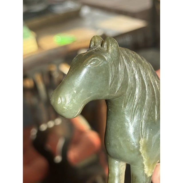 A magnificent and finely carved Chinese spinach green jade model of a horse, dating back to the 18th or 19th century...