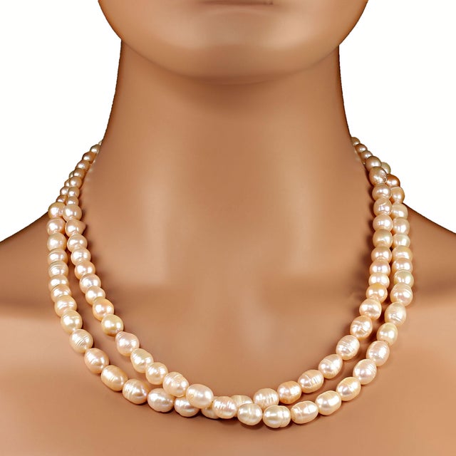 This is part of Chairish’s Fine Jewelry assortment. 21 Inch traditional 2 strand pearl necklace. These soft pink pearls...