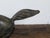 A small vintage bronze horse sculpture with dark patina and energetic pose. Discover the dynamic allure of this vintage...