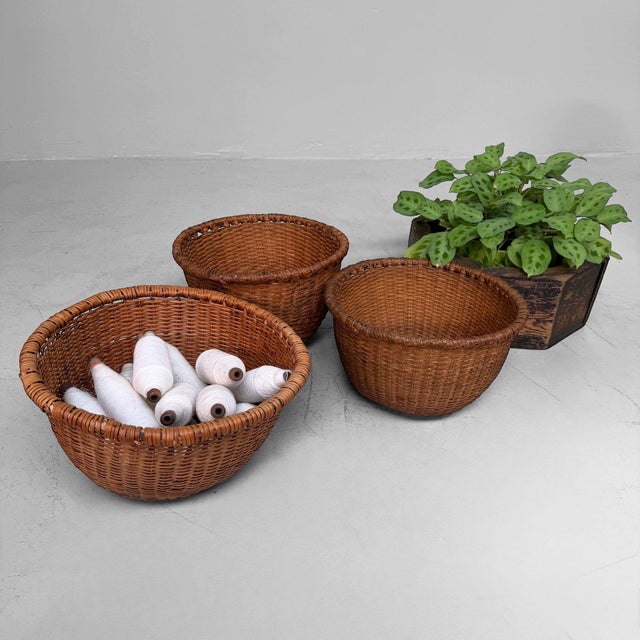 Decorative set of three vintage Japanese bamboo baskets, dating from around the 1960s. The baskets have a low rounded bowl...
