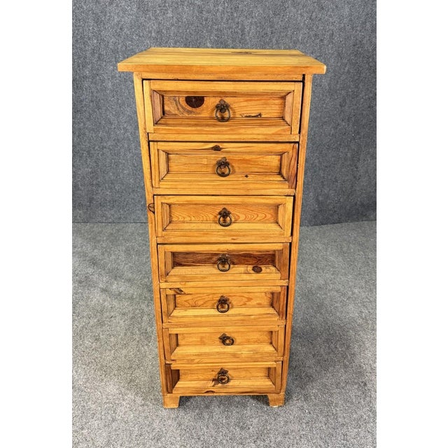 This vintage light pine seven-drawer lingerie chest, crafted in Mexico, features a warm natural finish that highlights the...